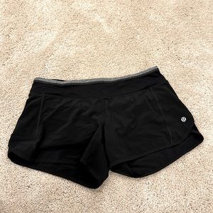 Black Lululemon running shorts with grey trim. Size 6